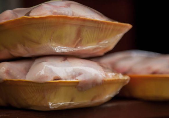 Fresh raw chicken shin meat in yellow tray on dark background. Fresh meat is ready to prepare delicious meal. Raw chicken steak for banner or website format. Copy space site